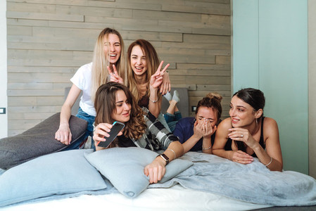 five girls on the bed in the bedroom