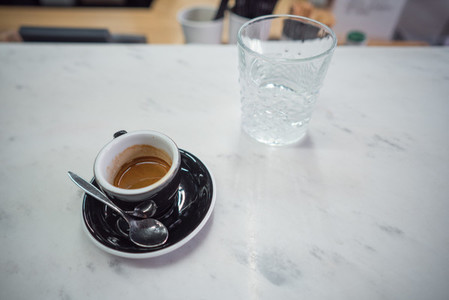 coffee mug and a glass of water on a table