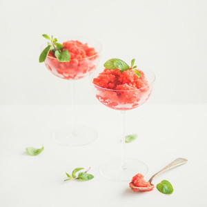 Strawberry and champaigne summer granita with mint in champagne glasses
