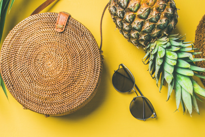 Colorful summer female outfit over yellow background, wide composition