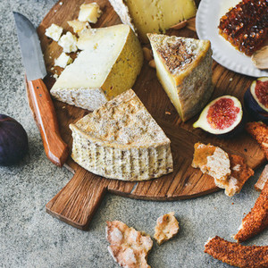 Cheese assortment  figs  honey  fresh bread and nuts  square crop