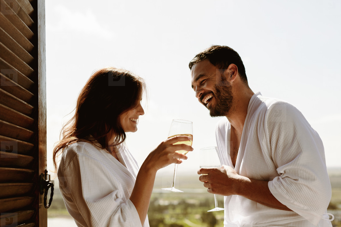 Couple talking over a glass of wine at home