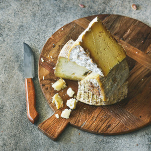 Cheese assortment on board close up vertical composition