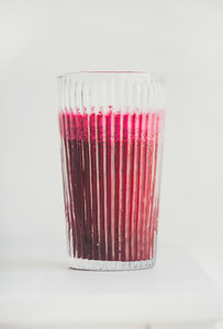 Fresh detox beetroot smoothie in glass  white background  copy space