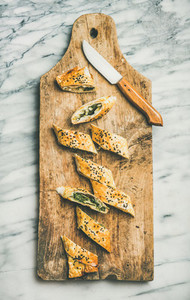 Freshly baked Turkish borek roll slices with cheese and spinach