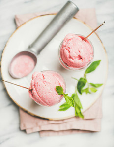 Homemade strawberry yogurt ice cream with fresh mint  top view