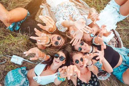 Six girls lie on the grass