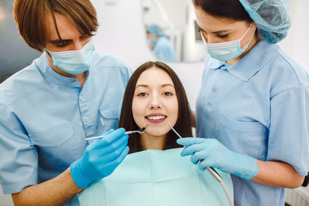 The girl on reception at the dentist with assistant