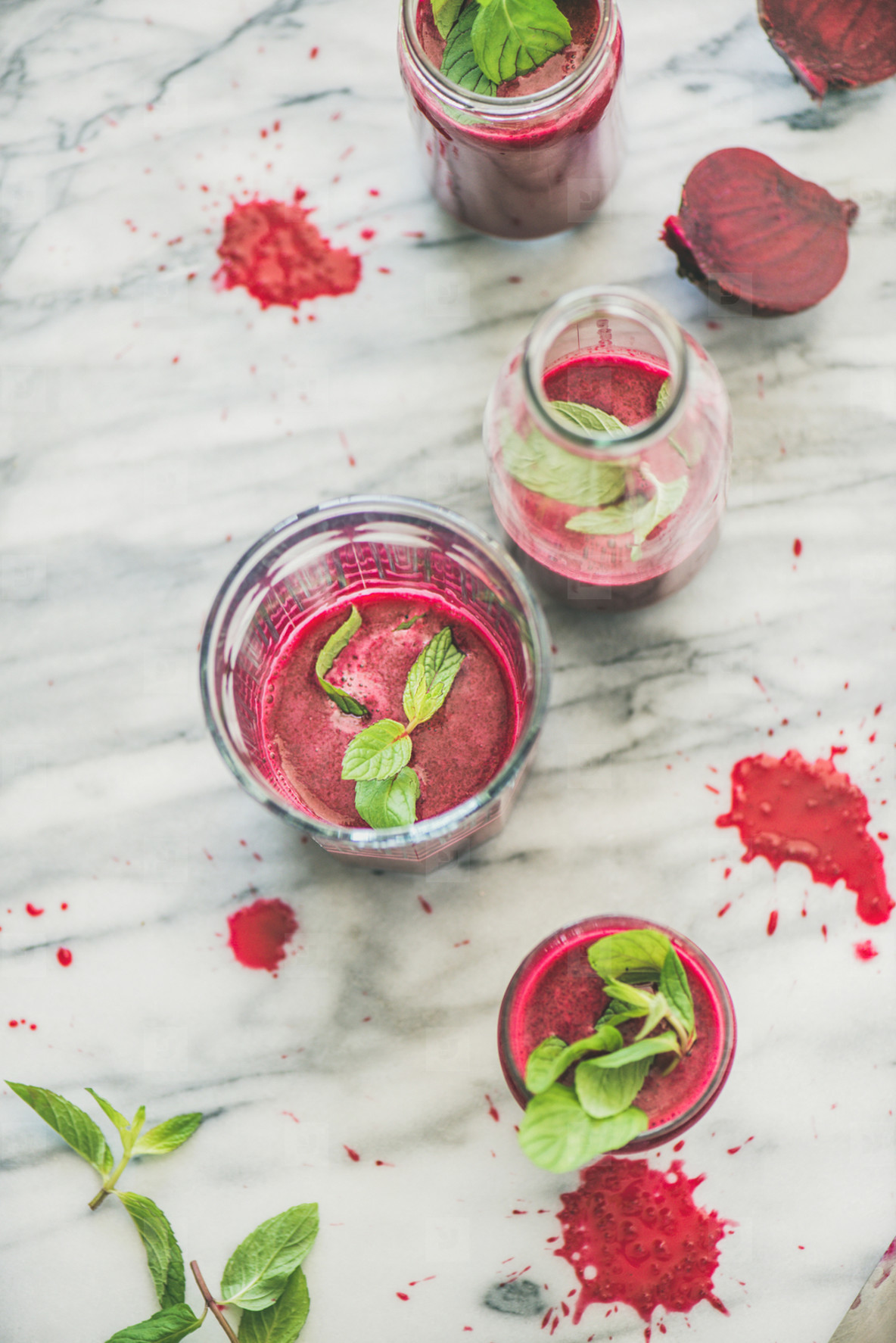 Fresh morning beetroot smoothie in glasses over grey marble background
