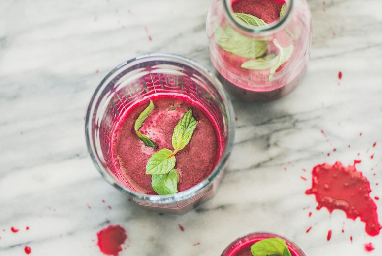 Fresh morning beetroot smoothie in glasses over grey marble background