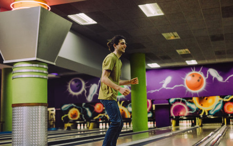Man playing at bowling alley