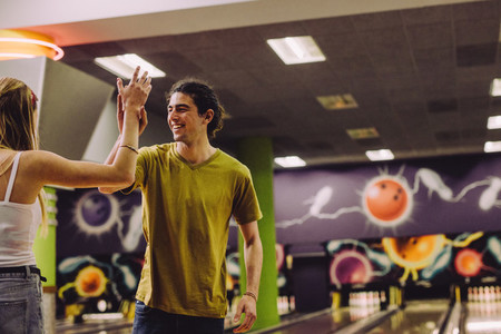 Couple celebrating bowling strike