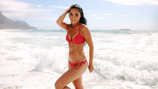Beautiful woman posing in swimsuit on beach