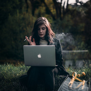 Young hipster girl with a laptop