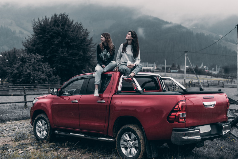 the girls get on the car and look at the mountains