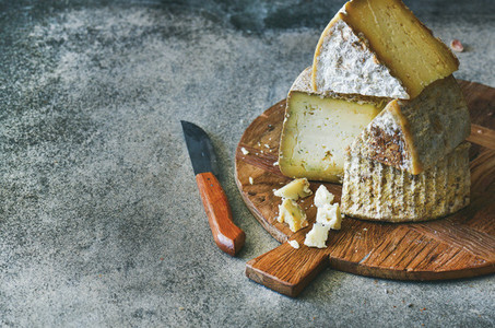 Cheese assortment on wooden board copy space