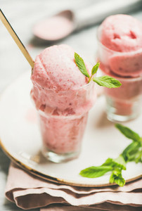 Homemade strawberry yogurt ice cream with mint leaves