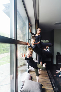 Mom and two daughters practice ballet
