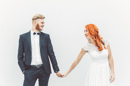 Wedding couple on a background of whitewall