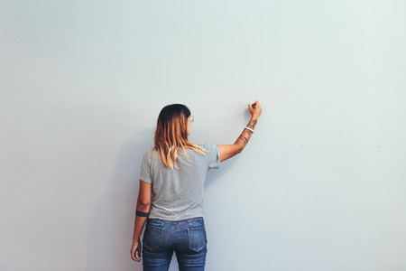 Woman drawing on a wall