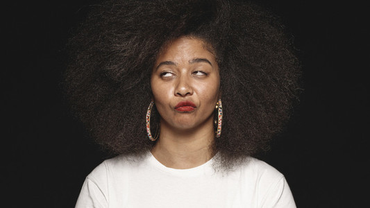 Woman in afro hairstyle making faces