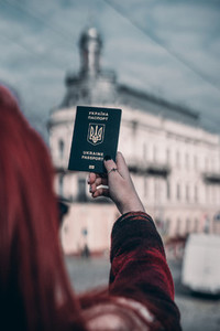 hands of the girl hold the passport in hand