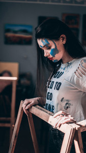 Artist girl with a handprint on face Concept art with paint
