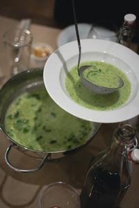 Pouring creamy spinach soup