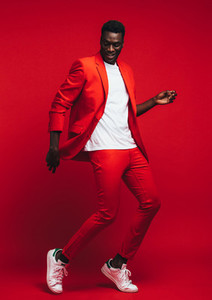 Man dancing on red background