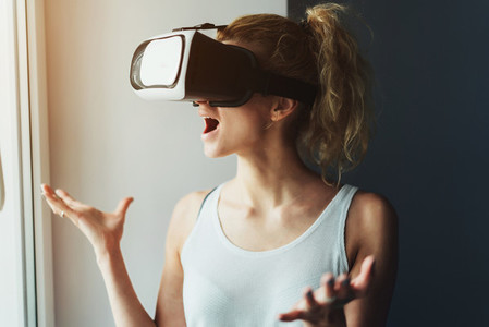 Woman in VR headset looking up