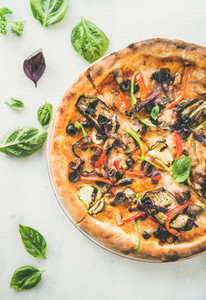 Freshly baked vegetarian pizza over marble background