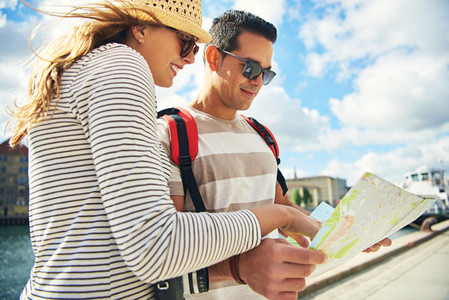 Young tourist couple looking at a map