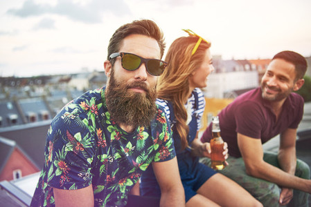 Handsome bearded man with friends on roof