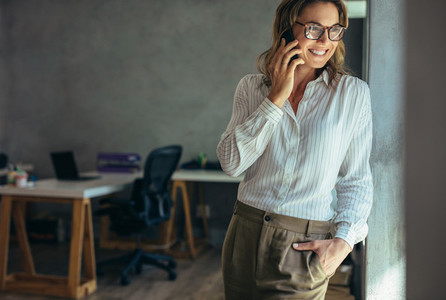 Relaxed businesswoman talking on cell phone