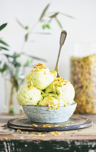Bowl of homemade pistachio ice cream dessert with nuts