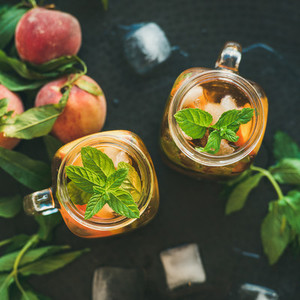 Summer refreshing cold peach ice tea in jars  square crop