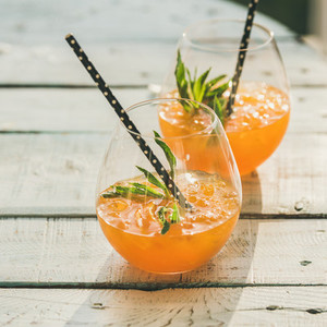 Refreshing cold alcoholic summer citrus cocktail with orange  square crop