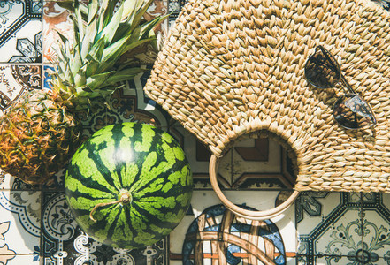 Summer lifestyle background with fruits and straw bag close up