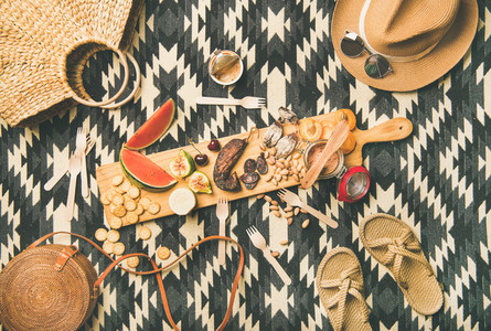 Picnic concept with sausage  fruit  cheese  pate and straw accessories
