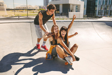 Group of teenagers enjoying outdoors with skateboard