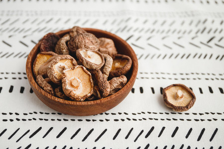 Chinese dried mushrooms Shiitake in a wooden bowl on a table  The concept of medicinal superfoods for health