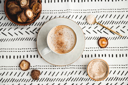 Top view of mushroom latte with Shiitake powder and vegetarian blend milk  Healthy useful vegan drink  flat lay