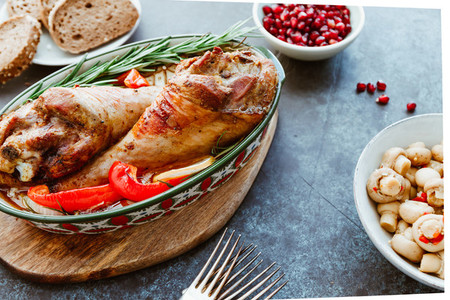 Festive dish for Thanksgiving  roasted turkey legs with vegetables on a table with snacks