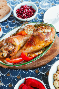 Festive dish for Thanksgiving  roasted turkey legs with vegetables on a table with snacks