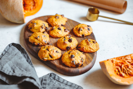 Pumpkin cookies with chocolate chips made from cake mix on a wooden tray