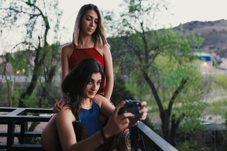 Two young women take a selfie on the balcony