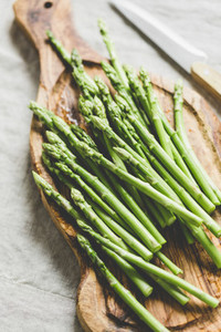 Fresh asparagus on a wooden cutting board  Preparation vegetarian healthy food