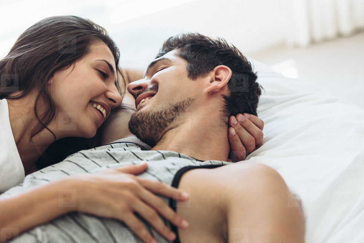 Young couple man and woman in bed top view sleeping girl trying move guy's  leg uncomfortable pose Stock Photo - Alamy