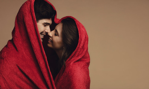 Couple in love wrapped in a blanket