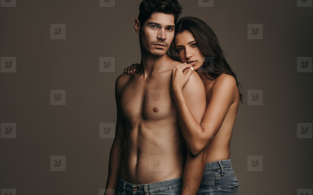 Sensual couple on brown background